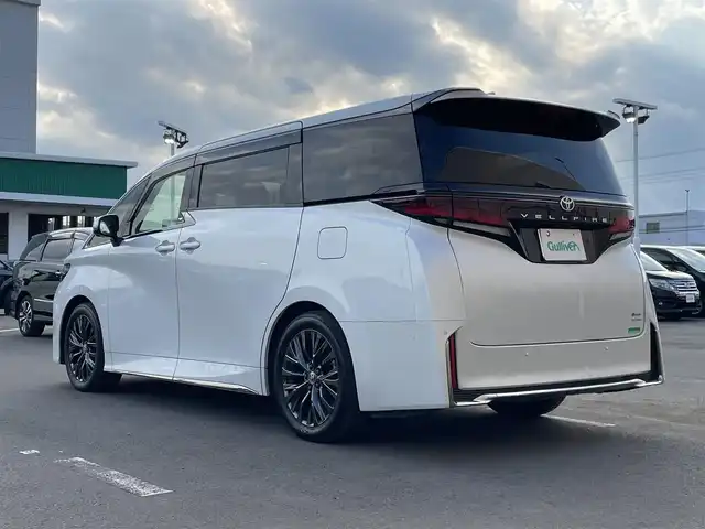 トヨタ ヴェルファイア ハイブリット Z プレミア 東京都 2024(令6)年 3.5万km プラチナホワイトパールマイカ ワンオーナー/純正１４型ディスプレィオーディオナビ　/・BluetoothAudio/HDMI/USB/・AppleCarPlay＆AndroidAuto/純正１３型フリップダウンモニター　/左右独立ムーンルーフ　/ブラインドスポットモニター　/3眼LEDヘッドライト /トヨタチームメイト /・アドバンストパーク/・パーキングサポートブレーキ/・アドバンストドライブ/・リモート機能/サンセットブラウンレザーシート/・快適温熱シート/・前席パワーシート/セーフティセンス/（予防安全パッケージ）/・プリクラッシュセーフティ/・レーンチェンジアシスト/・レーンディパーチャーアラート/・全車速追従機能付レーダークルーズコントロール/・アダプティブハイビームアシスト/プッシュエンジンスタート/置くだけ充電/スマートキー/保証書＆取説