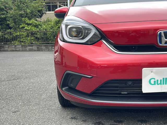 ホンダ フィット e:HEVホーム 埼玉県 2020(令2)年 0.6万km プレミアムクリスタルレッドM 登録時5938km/ワンオーナー/純正SDナビ（VXU-215FTi）/　AM/FM/CD/DVD/BT/MSV/フルセグTV/バックカメラ/純正ナビ連動ドライブレコーダー（前後）/衝突軽減ブレーキ（CMBS）/踏み間違え衝突軽減ブレーキ/路外逸脱抑制機能/横滑り防止機能/コーナーセンサー/プッシュスタート/スマートキー×２/LEDヘッドライト/　オートライト/オートマッチクハイビーム/　ライトレベライザー/電動パーキングブレーキ/オートブレーキホールド/ステアリングリモコン/電動格納機能付ウインカーミラー/ドアバイザー/純正フロアマット/ナビ取扱説明書/取扱説明書/保証書