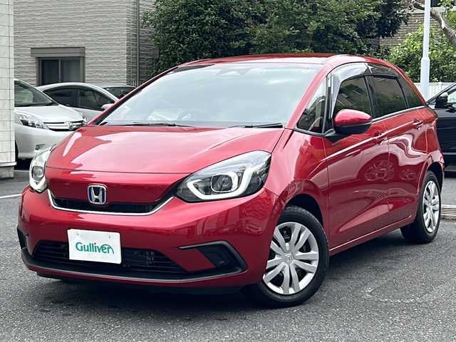 ホンダ フィット e:HEVホーム 埼玉県 2020(令2)年 0.6万km プレミアムクリスタルレッドM 登録時5938km/ワンオーナー/純正SDナビ（VXU-215FTi）/　AM/FM/CD/DVD/BT/MSV/フルセグTV/バックカメラ/純正ナビ連動ドライブレコーダー（前後）/衝突軽減ブレーキ（CMBS）/踏み間違え衝突軽減ブレーキ/路外逸脱抑制機能/横滑り防止機能/コーナーセンサー/プッシュスタート/スマートキー×２/LEDヘッドライト/　オートライト/オートマッチクハイビーム/　ライトレベライザー/電動パーキングブレーキ/オートブレーキホールド/ステアリングリモコン/電動格納機能付ウインカーミラー/ドアバイザー/純正フロアマット/ナビ取扱説明書/取扱説明書/保証書