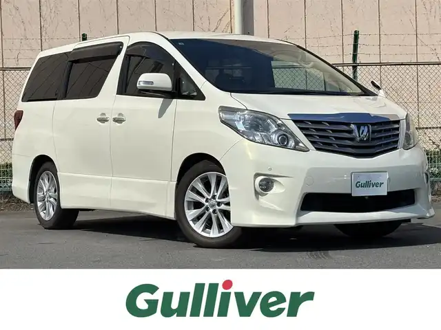 トヨタ アルファード 350S Cパッケージ 東京都 2009(平21)年 12万km ゴールドパールクリスタルシャイン ナビ/バック/サイドカメラ/ETC/ドラレコ/クリアランスソナー/バックソナー/クルーズコントロール/パワースライドドア（運転席側/助手席側）/パワーバックドア/車名ロゴ入スカッフプレート/スモーク加飾付HIDヘッドランンプ/インテリジェントAFS /コンライト（オートライト）/サイドクラッディングパネル/リアスポイラー/リアエアロバンパー/スモークレンズLEDリアコンビネーションランプ/マフラーカッター/リバース連動機能付ボディ同色電動オート格納ドアミラー/ウィンカーミラー/照射証明付ブルー指針オプティトロンメーター（自発光式アナログメーター）/SRSエアバッグ（運転席/助手席/サイド/カーテン/ニー)/左右独立温度調整オートエアコン/リアオートエアコン/内外気自動切替システム/プラズマクラスター/足元照明（運転席/助手席）/オーバーヘッドコンソール/パワーシート（運転席/助手席）/パワーオットマン（助手席）/マイコンプリセットドライビングポジションシステム/2列目シートエグゼクティブパワーシート/パワーオットマン/パワーリクライニング/カップホルダー付大型アームレスト/角度調整式大型ヘッドレスト