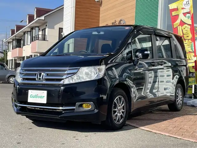 ホンダ ステップワゴン G Eセレクション 道央・札幌 2014(平26)年 13.7万km クリスタルブラックパール 登録時走行距離136/972km/ワンオーナー/　４　W　D　/寒冷地仕様/純正ナビ（CD/DVD/FM/AM/SD)/フルセグ（走行中視聴可能）/バックカメラ/アイドリングストップ/ウィンカーミラー/クルーズコントロール（追従走行なし）/ドアバイザー/片側パワースライドドア/ビルトインETC/スペアキー×１/社外エンジンスターター/純正フロアマット/横滑り防止装置/フォグランプ/フロントデアイサースイッチ/ステアリングスイッチ/ミラーヒーター/電動格納ミラー/ワイパー間欠時間コントローラー/イルミネーションコントロール/ヘッドライトレベライザー/ECONスイッチ/積込冬タイヤ（社外AW/205/65/R15/16年製/溝5ｍｍ）