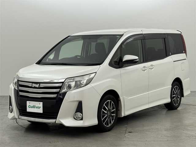 トヨタ ノア Si 福岡県 2015(平27)年 9.8万km ホワイトパールクリスタルシャイン フリップダウンモニター　/純正ナビ（ＢＴ，フルセグＴＶ）　/バックカメラ　/ビルトインＥＴＣ　/衝突軽減ブレーキ　/レーンキープ　/アイドリングストップ　/方側電動スライドドア　/ＭＴモード付き　/純正１６インチＡＷ