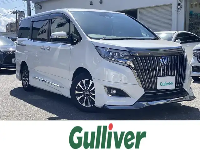 トヨタ エスクァイア ハイブリッド Gi プレミアムパッケージ ブラックテーラード 福岡県 2021(令3)年 8.4万km ホワイトパールクリスタルシャイン ワンオーナー/純正ディーラーナビ（NSZT-Z68T）/（AM/FM//CD/DVD/BT/フルセグTV）/モデリスタエアロ/クルーズコントロール/バックカメラ/フリップダウンモニター/前方ドライブレコーダー/ステアリングヒーター/クリアランスソナー/ビルトインETC/USB入力端子/ウォークスルー/LEDヘッドライト/オートマチックハイビーム/先行車発進告知/レーンキープアシスト/衝突被害軽減システム/純正15インチアルミホイール/純正フロアマット/スペアキー/取扱説明書/保証書