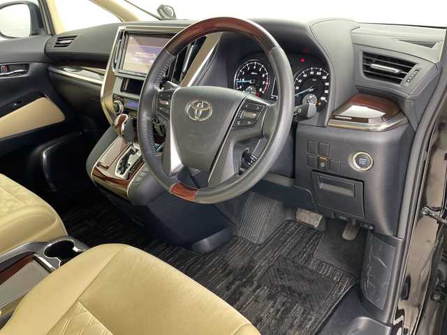 トヨタ ヴェルファイア V 道央・札幌 2015(平27)年 5.2万km バーニングブラッククリスタルシャインガラスフレーク ・4WD/・ワンオーナー/・純正ナビ/・BT&CD&DVD&SD＆フルセグTV/・バックカメラ/・純正フリップダウンモニター/・両側パワースライドドア/・助手席ロングスライド/・クルーズコントロール/・ハーフレザーシート/・D席メモリ付パワーシート/・ビルトインETC/・TVキャンセラー/・オットマン/・ステアリングスイッチ/・オートライト/・LEDヘッドライト/・プッシュスタート/・スマートキー/・スペアキー×1