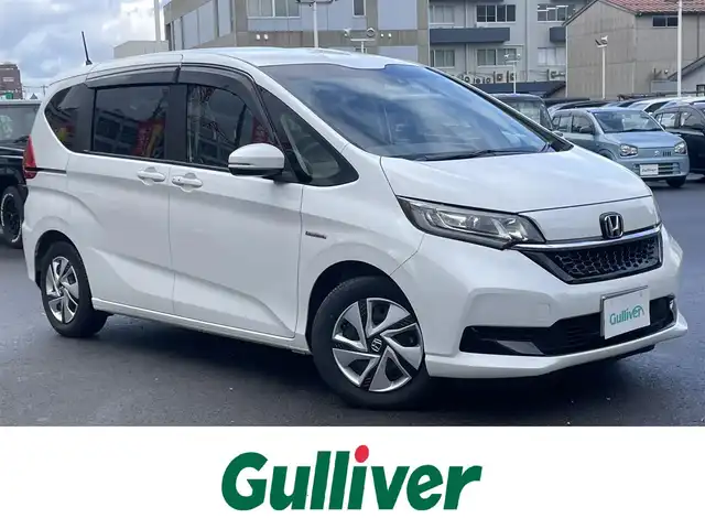 ホンダ フリード ハイブリット G ホンダセンシング 島根県 2020(令2)年 2.1万km プラチナホワイトパール 禁煙車/純正９インチメモリナビ　/フルセグＴＶ　/ＤＶＤ再生　/Ｂｌｕｅｔｏｏｔｈ接続　/バックカメラ　/ＥＴＣ　/前後ドライブレコーダー/両側パワースライドドア　/アダプティブクルーズコントロール　/衝突軽減ブレーキ　/レーンキープアシスト/後方コーナーセンサー　/前席シートヒーター　/スマートキー/純正ＬＥＤヘッドライト　/純正１５インチアルミホイール/純正フロアマット