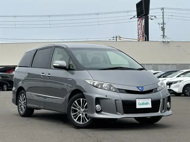 トヨタ エスティマ ハイブリッド アエラス プレミアムエディション 道東・釧路十勝 2015(平27)年 6.9万km アイスチタニウムマイカメタリック ４WD/プッシュスタート/オットマン(２列目後部座席)/純正ナビ（フルセグ/DVD/BT/CD）/バックカメラ/フリップダウンモニター/クルーズコントロール/ハーフレザーシート/運転席パワーシート/AC100Vコンセント/オートライト/キセノンライト/純正17インチAW/横滑り防止装置/アイドリングストップ/フロントフォグランプ/ウィンカーミラー/ナノイー/