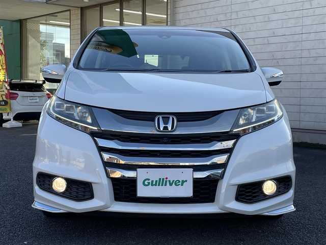 ホンダ オデッセイ ハイブリッド アブソルートセンシングEXパック 大分県 2016(平28)年 8.3万km ホワイトオーキッドパール 純正ナビ（3HU3）/【フルセグTV/Bluetooth/DVD/CD】/Honda SENSING/●衝突軽減ブレーキ 〈CMBS〉/●歩行者事故低減ステアリング/●ACC 〈アダプティブ・クルーズ・コントロール〉/●LKAS 〈車線維持支援システム〉/●路外逸脱抑制機能/●誤発進抑制機能/●先行車発進お知らせ機能/●標識認識機能/マルチビューカメラ/純正リアエンターテイメントシステム/両側パワースライドドア/前後ドラレコ（PDR800FR）/外部端子接続：HDMI・USB/運転席8ウェイパワーシート/LEDヘッドライト/2列目大型ロールサンシェード/2列目オットマン/純正ナビ（テレビ、DVD、FM、、Bluetooth）/ETC/スマートキー/電動格納ミラー/プッシュエンジン/ステアリングスイッチ/チルトステアリング/横滑り防止システム/ドアバイザー/純正フロアマット/スタッドレスタイヤ車載（215/55R17）/保証書/取扱説明書