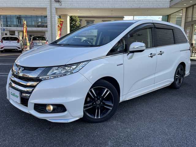 ホンダ オデッセイ ハイブリッド アブソルートセンシングEXパック 大分県 2016(平28)年 8.3万km ホワイトオーキッドパール 純正ナビ（3HU3）/【フルセグTV/Bluetooth/DVD/CD】/Honda SENSING/●衝突軽減ブレーキ 〈CMBS〉/●歩行者事故低減ステアリング/●ACC 〈アダプティブ・クルーズ・コントロール〉/●LKAS 〈車線維持支援システム〉/●路外逸脱抑制機能/●誤発進抑制機能/●先行車発進お知らせ機能/●標識認識機能/マルチビューカメラ/純正リアエンターテイメントシステム/両側パワースライドドア/前後ドラレコ（PDR800FR）/外部端子接続：HDMI・USB/運転席8ウェイパワーシート/LEDヘッドライト/2列目大型ロールサンシェード/2列目オットマン/純正ナビ（テレビ、DVD、FM、、Bluetooth）/ETC/スマートキー/電動格納ミラー/プッシュエンジン/ステアリングスイッチ/チルトステアリング/横滑り防止システム/ドアバイザー/純正フロアマット/スタッドレスタイヤ車載（215/55R17）/保証書/取扱説明書