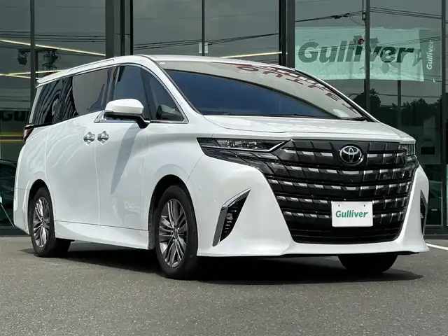 トヨタ アルファードハイブリット Z 鹿児島県 2024(令6)年 2.3万km プラチナホワイトパールマイカ 純正フリップダウンモニター/純正メモリナビ/　　CD/DVD/BT/フルセグ/アラウンドビューモニター/両側パワースライドドア/LEDヘッドライト/レザーシート/純正18インチアルミホイール/純正ビルトインETC2.0/オットマン/電動リアゲート/社外ドライブレコーダー