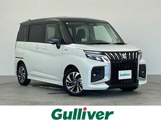 スズキ ソリオ バンディット HV MV 愛知県 2025(令7)年 1.2万km ピュアホワイトパール/ガンメタリック2トーン 禁煙車/純正ナビ(AM/FM/CD/DVD/BT/USB/HDMI/フルセグ/カープレイ/ドロオート)/全方位カメラ/ETC/ドライブレコーダー前後/全席シートヒーター/純正15インチアルミホイール/デュアルブレーキサポートII/前後方誤発進抑制/前後方低速時ブレーキサポート/フロントリヤパーキングセンサー/レーンキープアシスト/ふらつき警報/クルーズコントロール/LEDヘッドライト/オートライト/フォグランプ/両側パワースライドドア/アイドリングストップ/後席サンシェード/電動格納ミラー/革巻きステアリング/純正フロアマット/イモビライザー