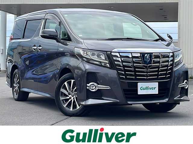 トヨタ アルファードハイブリット SR 道北・旭川 2016(平28)年 5.9万km グレーメタリック ・4WD/・禁煙車/・JBLプレミアムサウンド＆１２．１リアエンターテインメントシステム/・トヨタ純正SDナビ/BT/フルセグ/AUX/DVD/CD/・両側パワースライドドア/・バックカメラ/・純正フリップダウンモニター/・プリクラッシュセーフティ/・追従型クルーズコントロール/・インテリジェントクリアランスソナー/・オートマチックハイビーム/・ハーフレザーシート/・オットマン/・アイドリングストップ/・ナノイー/・後席用LEDドームランプ/・ブレーキホールド/・ステアリングスイッチ/・前後コーナーセンサー/・電動パーキングブレーキ/・ETC/・LEDヘッドライト/・フォグランプ/・オートライト/・電動格納ミラー/・純正フロアマット/・保証書/・取扱説明書