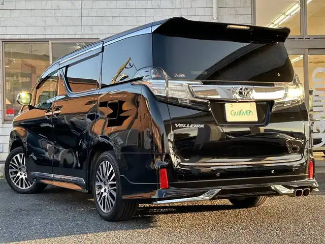 トヨタ ヴェルファイア Z Gエディション 福岡県 2015(平27)年 7.4万km ブラック モデリスタエアロ(リア)/フロントガーニッシュ/ツインムーンルーフ/純正10.1インチフリップダウンモニター/JBLプレミアムサウンド/純正9インチメーカーナビ/(AM/FM/CD/DVD/Bluetooth/フルセグTV)/全方位カメラ/バック/フロント/サイドカメラ/運転支援/・プリクラッシュセーフティシステム/・クリアランスソナー/・レーダークルーズコントロール/横滑り防止/純正18インチアルミホール/両側パワースライドドア/パワーバックドア/純正LEDスタイリッシュビーム(フロントガーニッシュ用)/黒レザーシート/レーダー探知機【ASSURA AR-W51GA】/ビルトインETC/純正インテリアイルミネーション/純正スカッフイルミネーション/ステアリングヒーター/革巻きステアリング/ステアリングスイッチ/パワーシート(D/N)/シートヒーター(D/N)/シートメモリー(D)/オットマン(N/セカンドシート)/後席電動サンシェード/純正フロアマット/ナノイー/ドアバイザー/ブレーキホールド/プッシュスタート/USBポート/スペアキー×1/100V電源/ISOFIX/保証書/取説、ナビ取説