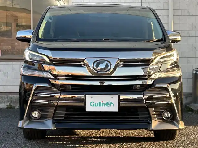 トヨタ ヴェルファイア Z Gエディション 福岡県 2015(平27)年 7.4万km ブラック モデリスタエアロ(リア)/フロントガーニッシュ/ツインムーンルーフ/純正10.1インチフリップダウンモニター/JBLプレミアムサウンド/純正9インチメーカーナビ/(AM/FM/CD/DVD/Bluetooth/フルセグTV)/全方位カメラ/バック/フロント/サイドカメラ/運転支援/・プリクラッシュセーフティシステム/・クリアランスソナー/・レーダークルーズコントロール/横滑り防止/純正18インチアルミホール/両側パワースライドドア/パワーバックドア/純正LEDスタイリッシュビーム(フロントガーニッシュ用)/黒レザーシート/レーダー探知機【ASSURA AR-W51GA】/ビルトインETC/純正インテリアイルミネーション/純正スカッフイルミネーション/ステアリングヒーター/革巻きステアリング/ステアリングスイッチ/パワーシート(D/N)/シートヒーター(D/N)/シートメモリー(D)/オットマン(N/セカンドシート)/後席電動サンシェード/純正フロアマット/ナノイー/ドアバイザー/ブレーキホールド/プッシュスタート/USBポート/スペアキー×1/100V電源/ISOFIX/保証書/取説、ナビ取説