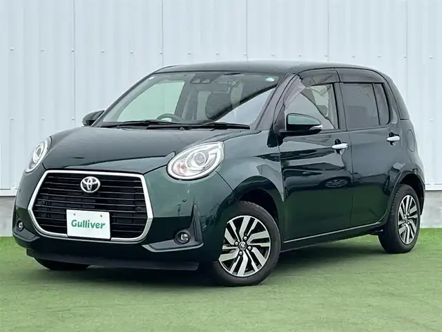 トヨタ パッソ モーダ　Gパッケージ 香川県 2019(平31)年 2.9万km ダークエメラルドマイカ 社外メモリーナビ/→AM/FM/CD/DVD/Bluetooth/フルセグTV/前後ドライブレコーダー/衝突軽減ブレーキ/ビルトインＥＴＣ/アイドリングストップ/LEDヘッドライト/コーナーセンサー/オートハイビーム/シートヒーター/プッシュスタート/スマートキー/スペアキー×1/革巻きステアリング/ステアリングスイッチ/純正フロアマット/純正14インチアルミホイール