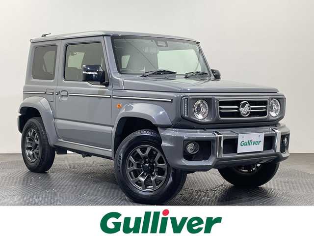 スズキ ジムニー シエラ JC 愛媛県 2025(令7)年 0.5万km ミディアムグレー ダムドlittle G. フロントグリル/ダムドlittle G. フロントバンパー/ダムドlittle G. オーバーフェンダー/ダムドlittle G. リアバンパー/背面ハードタイヤカバー/サイドメッキモール/デジタルインナーミラー//社外ナビ　ダムドトリムＧグリル＆バンパー　デジタルインナーミラー　ＥＴＣ　クルーズコントロール　コーナーセンサー　レーンアシスト　衝突被害軽減ブレーキ　バックカメラ　背面タイヤ　禁煙車