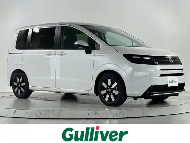 ホンダ フリード ハイブリット e:HEV AIR EX 佐賀県 2025(令7)年 0.1千km プラチナホワイトパール 純正9インチナビ/フルセグTV/Bluetooth/Android Auto/Applecarplay/衝突被害軽減装置/バックカメラ/レーダークルーズコントロール/レーンアシスト/ブラインドスポットモニター/クリアランスソナー/オートライト/オートマチックハイビーム/LEDヘッドライト/電子パーキング/ブレーキホールド/両側パワースライドドア/ハーフレザーシート/運転席・助手席シートヒーター/サーキュレーター/後席サンシェード/純正15インチアルミホイール/スマートキー/スペアキー×1