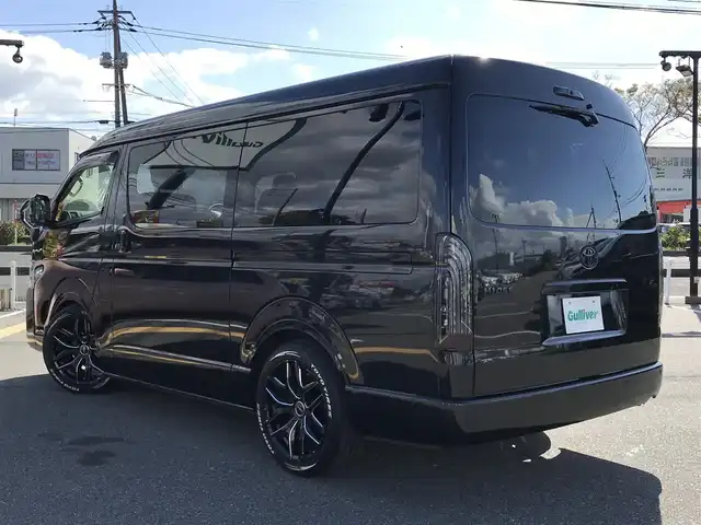 トヨタ ハイエース GL 鳥取県 2021(令3)年 5.8万km ブラックマイカ 社外10インチナビフローティングナビ/(フルセグ/DVD/ブルーレイ/CD/BT）/全方位カメラ・ETC/デジタルインナーミラー/カロッツエリアフリップダウンモニター/FLEXシート（対面/対座/フラットシート）/センターテーブル（脱着可能）/トヨタセーフティセンス/レーンアシスト/前後クリアランスソナー/片側パワースライドドア/LEDヘットライト/フォグランプ/ブラックインナーヘットライト/ローダウン/オートハイビーム/社外18インチアルミホイール/TOYOホワイトレター/社外テールランプ/レザー調シートカバー/プッシュエンジンスタート/スペアキー