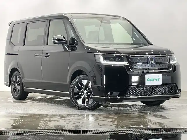 ホンダ ステップワゴン スパーダ eHEV 栃木県 2025(令7)年 0.1千km クリスタルブラックパール 登録済未使用車/純正11.4インチナビ/　(CD/DVD/Bluetooth/USB/フルセグTV)/バックカメラ/全方位カメラ/ホンダセンシング/・衝突軽減ブレーキ（CMBS）/・先行車発進お知らせ機能/・歩行者事故低減ステアリング/・路外逸脱抑制機能/・標識認識機能/・渋滞追従機能付アダプティブクルーズコントロール（ACC）/・車線維持支援システム（LKAS）/・トラフィックジャムアシスト（渋滞運転支援機能）/・ブラインドスポットインフォメーション/・誤発進抑制機能/・後方誤発進抑制機能/・近距離衝突軽減ブレーキ/・急アクセル抑制機能/・パーキングセンサーシステム/・オートハイビーム/両側パワースライドドア/電動リアゲート/2列目オットマン/ハーフレザーシート/前席シートヒーター/全列USBチャージャー/純正16インチAW/LEDヘッドライト