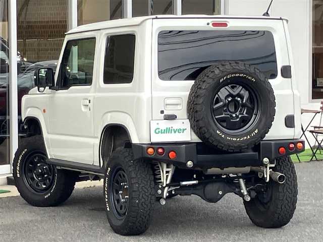 スズキ ジムニー XC 山口県 2021(令3)年 1.5万km ピュアホワイトP ワンオーナー/APIO静香御前マフラー/TANIGUCHI SOLVE AC60サス/　6cmリフトアップキット取り付け/APIOタクティカルリアバンパー/KLCヘリテージトラディショナルFバンパー/10インチメモリーナビ・フルセグTV/バックカメラ/前後ドライブレコーダー/スマートキー/フロントシートヒーター/クルーズコントロール/レーンアシスト/衝突被害軽減システム/LEDオートライト/フォグランプ