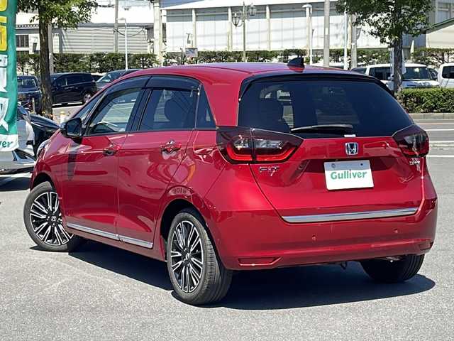 ホンダ フィット e:HEVリュクス 長野県 2021(令3)年 5.7万km プレミアムクリスタルレッドM 純正9インチメモリナビ/(VXU-215Fi)/フルセグTV/CD/DVD/バックカメラ/USB入力端子/Bluetooth接続/純正16インチアルミホイール/社外AW付スタッドレス車載/クルーズコントロール　/ステアリングスイッチ　/ステアリングヒーター　/ＬＥＤヘッドライト　/衝突軽減システム/コーナーセンサー/ハンドルヒーター/ウインカーミラー/ワイヤレス充電/ミラーヒーター/オートライト/横滑り防止　/盗難防止　/ＥＴＣ