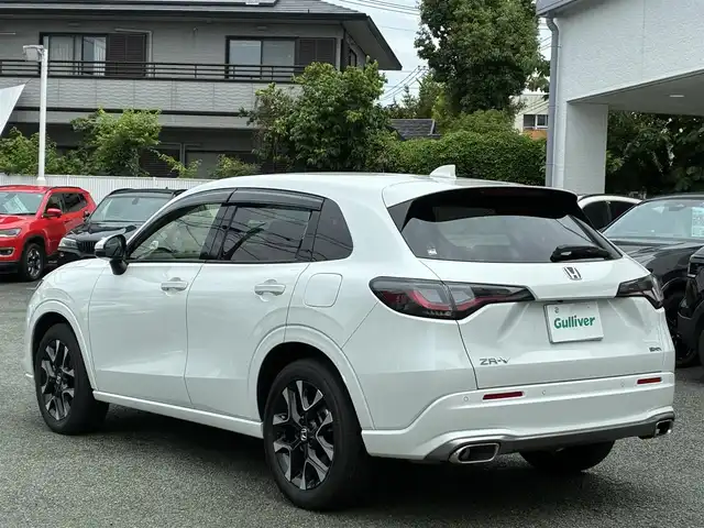 ホンダ ＺＲ－Ｖ ハイブリッド e:HEV Z 熊本県 2024(令6)年 1.3万km プラチナホワイトパール BOSEサウンド/純正ナビ/【フルセグTV/Bluetooth/USB/ラジオ】/全方位カメラ/レーダークルーズコントロール/パドルシフト/衝突軽減ブレーキ/レーンキープアシスト/先行車発進お知らせ機能/パーキングセンサー/ダウンヒルアシスト/標識認識機能/黒革シート/前席パワーシート/運転席シートメモリ/前席シートヒーター/ビルトインETC2.0/前後ドライブレコーダー（DRH-224SD）/横滑り防止機能/ブレーキホールド/純正18インチAW/ワイヤレス充電/ステアリングヒーター/革巻きステアリング/ステアリングスイッチ/オートライト/LEDヘッドライト/純正フロアマット/ドアバイザー/保証書/取扱説明書