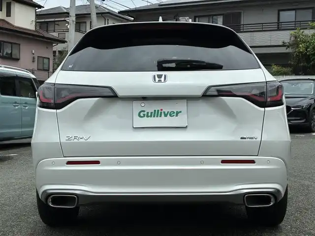 ホンダ ＺＲ－Ｖ ハイブリッド e:HEV Z 熊本県 2024(令6)年 1.3万km プラチナホワイトパール BOSEサウンド/純正ナビ/【フルセグTV/Bluetooth/USB/ラジオ】/全方位カメラ/レーダークルーズコントロール/パドルシフト/衝突軽減ブレーキ/レーンキープアシスト/先行車発進お知らせ機能/パーキングセンサー/ダウンヒルアシスト/標識認識機能/黒革シート/前席パワーシート/運転席シートメモリ/前席シートヒーター/ビルトインETC2.0/前後ドライブレコーダー（DRH-224SD）/横滑り防止機能/ブレーキホールド/純正18インチAW/ワイヤレス充電/ステアリングヒーター/革巻きステアリング/ステアリングスイッチ/オートライト/LEDヘッドライト/純正フロアマット/ドアバイザー/保証書/取扱説明書