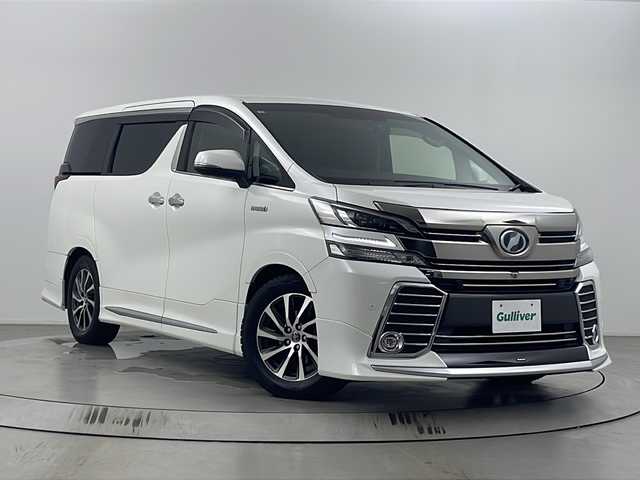 トヨタ ヴェルファイア ハイブリット ZR 埼玉県 2015(平27)年 7.3万km ホワイトパールクリスタルシャイン モデリスタエアロ/後席モニター/JBLプレミアムサウンド/全方位カメラ/純正メモリナビ/フルセグテレビ/オットマン/電動リアゲート/パワーシート/前後ドライブレコーダー/レーダークルーズコントロール/ビルトインETC/セーフティセンス/社外テールランプ積み込み/両側パワースライドドア/ステアリングリモコン/プッシュスタート/スマートキー/スペアキー/純正フロアマット/ハーフレザーシート