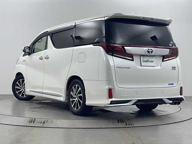 トヨタ ヴェルファイア ハイブリット ZR 埼玉県 2015(平27)年 7.3万km ホワイトパールクリスタルシャイン モデリスタエアロ/後席モニター/JBLプレミアムサウンド/全方位カメラ/純正メモリナビ/フルセグテレビ/オットマン/電動リアゲート/パワーシート/前後ドライブレコーダー/レーダークルーズコントロール/ビルトインETC/セーフティセンス/社外テールランプ積み込み/両側パワースライドドア/ステアリングリモコン/プッシュスタート/スマートキー/スペアキー/純正フロアマット/ハーフレザーシート