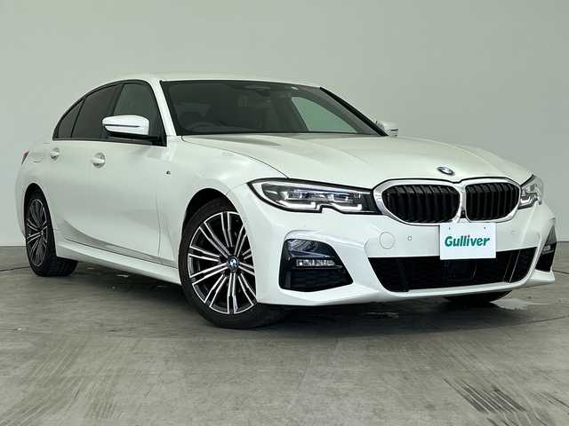 ＢＭＷ ３２０ｉ Mスポーツ 三重県 2020(令2)年 7万km 白 /禁煙車//BMWライブ・コックピット：//12.3インチ マルチ・ディスプレイ・メーター・パネル//10.25インチ ワイド・コントロール・ディスプレイ//HDDナビゲーション・システム//Mスポーツ専用マルチファンクション/　Mスポーツ・レザー・ステアリング・ホイール（パドルシフト付）//Mスポーツ専用スポーツ・シート（運転席&助手席）//アルカンタラ／センサテック・コンビネーション・シート/＜カラー：ブラック（ブルー・ステッチ付）＞//パーキング・アシスト：//PDC//パーキング・アシスト（並列・縦列）//リヤ・ビュー・カメラ（予想進路表示機能付）//ワイヤレス充電//レーダークルーズコントロール//インテリジェントセーフティ//衝突軽減ブレーキ//レーンキープアシスト//ブラインドスポットモニター//オートハイビーム//純正前後ドライブレコーダー