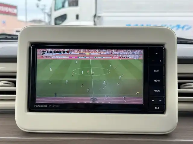 スズキ ラパン X 滋賀県 2024(令6)年 0.9万km フォーンベージュメタリック/ソフトベージュ 2トーン ワンオーナー/純正フルセグナビ/　フルセグ Bluetooth CD  DVD  SD FM AM/バックカメラ/デュアルカメラブレーキサポート/誤発進抑制機能/後退時ブレーキサポート/後方誤発進抑制機能/リヤパーキングセンサー/車線逸脱警報機能/ふらつき警報機能/先行車発進お知らせ機能/ハイビームアシスト/標識認識機能/ハイビームアシスト/純正ドライブレコーダー前後/純正LEDヘッドライト/純正14インチアルミ/純正フロアマット/ETC/スマートキー×2/プッシュスタート/