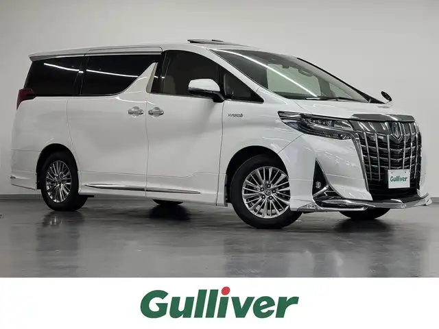 トヨタ アルファードハイブリット G Fパッケージ 三重県 2019(令1)年 11.2万km ホワイトパールクリスタルシャイン ハイブリッド/E-four（4WD）/MTモード付インパネCVT/純正 10インチナビ NSZN-Z68T/（AM/FM/CD/DVD/TV/SD/SDREC/Bluetooth）/バックガイドモニター/モデリスタエアロ（F/S/R下）/両側パワースライドドア/ドライブレコーダー 前後/ビルトイン ETC/Toyota Safety Sense/・プリクラッシュセーフティ/・レーントレーシングアシスト/・レーダークルコン（全車速追従機能付）/・アダプティブハイビームシステム/・インテリジェントクリアランスソナー（パーキングサポートブレーキ［静止物＆後方接近車］）/・【OP】ブラインドスポットモニター＆リヤクロストラフィックアラート/・ロードサインアシスト［RSA］/など/装備/・【OP】ツインムーンルーフ/・【OP】デジタルインナーミラー/・ベージュ本革シート/・AC100Vアクセサリーコンセント（1500W：5ヶ）/・シートヒーター＆ベンチレーション（D/N）/・ステアリングヒーター/・エグゼクティブパワーシート（D6way/N4way＆電動オットマン/2ndシート電動リクライニング・オットマン）/・両側パワースライドドア/・パワーバックドア/など