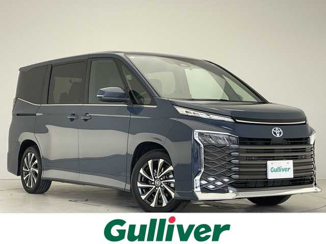 トヨタ ヴォクシー ハイブリッド S－Z 愛知県 2024(令6)年 0.8万km マッシブグレー 純正10.5型ディズプレイオーディオナビ/両側パワースライドドア/レーダークルーズコントロール/シートヒーター/バックカメラ/コーナーセンサー/純正アルミホイール/ETC2.0/LEDヘッドライト/インテリジェントミラー/リアオートエアコン/ドライブレコーダー/衝突軽減システム/フルセグ/CD DVD/Bluetooth/ステアリングスイッチ/スマートキー/プッシュスタート