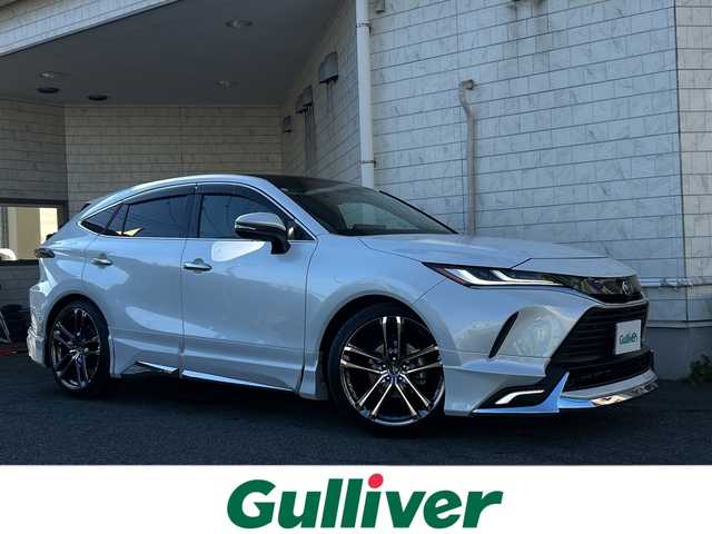 トヨタ ハリアー ハイブリッド Z レザーパッケージ 神奈川県 2023(令5)年 2.7万km プラチナホワイトパールマイカ JBLサウンドシステム/調光パノラマルーフ/モデリスタエアロ/wedsクレンツェ21インチアルミ/純正ナビ(AM/FM/USB/BT/フルセグTV/Miracast)/パノラミックビューモニター/RS-Rダウンサス/衝突被害軽減ブレーキ/レーンキープアシスト/ブラインドスポットモニター/クリアランスソナー/オートハイビーム/レーダークルーズコントロール/黒革シート/D/N席エアーシート/D/N席パワーシート(D席メモリー)/ステアリングヒーター/デジタルインナーミラー/ヘッドアップディスプレイ/パワーバックドア/ビルトインETC2.0/前方ドライブレコーダー/社外GPSレーダー/純正夏タイヤ付AW積込/スペアキー×1/保証書/取扱説明書