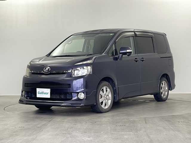 トヨタ ヴォクシー ZS 栃木県 2007(平19)年 17.6万km ダークバイオレットマイカメタリック 社外7インチナビ/AM FM CD DVD HDD AUX フルセグTV/ETC/フリップダウンモニター/両側パワースライドドア/パドルシフト/オートエアコン/フォグランプ/電動格納ミラー/スマートキー×2/純正マット/純正アルミホイール