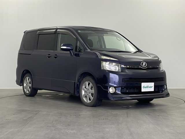 トヨタ ヴォクシー ZS 栃木県 2007(平19)年 17.6万km ダークバイオレットマイカメタリック 社外7インチナビ/AM FM CD DVD HDD AUX フルセグTV/ETC/フリップダウンモニター/両側パワースライドドア/パドルシフト/オートエアコン/フォグランプ/電動格納ミラー/スマートキー×2/純正マット/純正アルミホイール