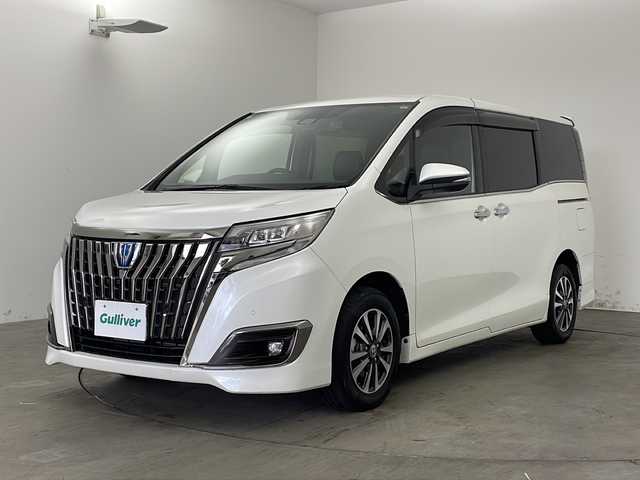 トヨタ エスクァイア ハイブリッド Gi プレミアムパッケージ ブラックテーラード 兵庫県 2021(令3)年 5.8万km ホワイトパールクリスタルシャイン ・社外9インチSDナビ（X9NX）/CD/DVD/SD/BT/フルセグ/・バックカメラ/・ビルトインETC/・Toyota　Safety　Sense/プリクラッシュセーフティ/レーンディパチャーアラート/オートマチックハイビーム/先行車発進告知/・クルーズコントロール/・横滑り防止装置/・パーキングサポートブレーキ/・車両接近通報装置/・両側パワースライドドア/・ステアリングスイッチ/・ステアリングヒーター/・合皮シート/・前席シートヒーター/・純正フロアマット/・ＬＥＤヘッドライト/・オートライト/・純正15インチアルミホイール/・ドライブレコーダー/・スマートキー/・スペアキー/・クリアランスソナー/・取扱説明書/・保証書