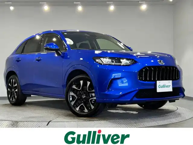 ホンダ ＺＲ－Ｖ ハイブリッド e:HEV Z 愛知県 2023(令5)年 1.2万km プレミアムクリスタルブルークリスタル 純正９型ホンダコネクトナビ　/(FM/AM/USB/Bluetooth/フルセグTV/スマホ連載）/ＢＯＳＥサウンド　/アラウンドビューモニター　/ホンダセンシング　/　　-衝突軽減ブレーキ（CNBS)/　　-誤発進抑制機能/　　-路線逸脱抑制機能/　　-アダプティブクルーズコントロール（ACC)/　　-先行車発進お知らせ機能/　　-標識認識機能/　　-オートハイビーム/　　-ブラインドスポットモニター/　　-パーキングセンサー/ステアリングヒーター　/茶革シート　/ビルトインＥＴＣ２．０　/電動バックドア　/メモリー付パワーシート　/シートヒーター/LEDヘッドライト