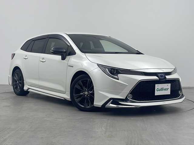 トヨタ カローラツーリング ハイブリッド ダブルバイビー 三重県 2019(令1)年 7.2万km ホワイトパールクリスタルシャイン 禁煙車/純正9インチナビ/（Bluetooth・MiraCast）/バックカメラ/トヨタセーフティセンス/・プリクラッシュセーフティ/・オートマチックハイビーム/・レーントレーシングアシスト/・ロードサインアシスト/・レーダークルーズコントロール/社外フルエアロ/電子パーキング/ブラインドスポットモニター/前席シートヒーター/ステアリングススイッチ/ビルトインETC2.0                                              /スペアタイヤ