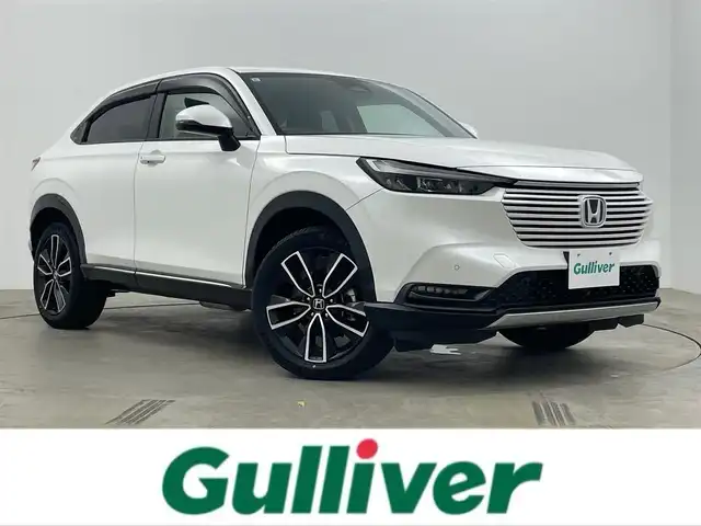ホンダ ヴェゼル ハイブリッド e:HEV Z 岡山県 2021(令3)年 4万km プラチナホワイトパール Honda SENSING	/・衝突軽減ブレーキ	/・オートハイビーム	/・誤発進抑制機能	/・後方誤発進抑制機能	/・路外逸脱警報機能	/・アダプティブクルーズコントロール	/・車線維持支援システム	/・先行車発進お知らせ機能		/純正９インチメモリナビゲーション		/【フルセグ/Bluetooth/DVD/MSV】		/バックカメラ		/純正18inアルミホイール+サマータイヤ：装着			/レーダークルーズコントロール		/ビルトインETC		/LEDヘッドライト（AUTO機能付き）		/シートヒーター		/横滑り防止機能			/ドライブレコーダー				/スマートキー		/ステアリングスイッチ		/プッシュスタート		/コーナーセンサー				/フロアマット			/スペアキー×１