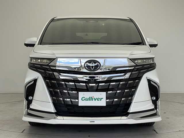 トヨタ アルファードハイブリット Z 愛知県 2024(令6)年 1.1万km プラチナホワイトパールマイカ 衝突軽減システム/モデリスタエアロ/純正ディスプレイオーディオ（ナビあり）/フリップダウンモニター/三眼LEDヘッドライト/全方位カメラ/両側パワースライドドア/Wサンルーフ/レーダークルーズコントロール/シートヒーター/エアシート/フルセグ/CD/DVD/Bluetooth/バックカメラ/電動リアゲート/パワーシート/コーナーセンサー/純正アルミホイール/ETC２．０/ブラインドスポットモニター/パドルシフト/ステアリングヒーター/インテリジェントミラー/リアオートエアコン/オートマチックハイビーム/置くだけ充電器/ドライブレコーダー