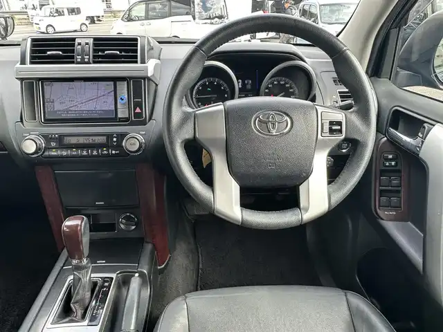 トヨタ ランドクルーザー プラド TX Lパッケージ 愛知県 2016(平28)年 8.3万km ブラック ワンオーナー/4WD/後席フリップダウンモニター/レザーシート/パワーシート/シートヒーター/横滑り防止/純正ビルトインETC/ドアミラーウィンカー/・オートライト/フォグランプ/フロントバンパー（モデリスタ）/保証書/取扱説明書