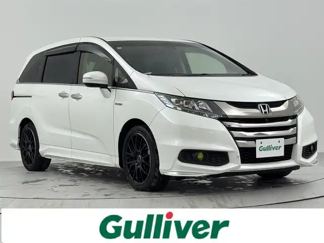 ホンダ オデッセイ ハイブリッド アブソルート・EXホンダセンジング 熊本県 2016(平28)年 6.6万km ホワイトオーキッドパール 本革シート/純正メモリーナビゲーション/・フルセグTV/CD/DVD/USB/HDMI/Bluetooth/リヤエンターテイメントシステム/マルチビューカメラ/前方ドライブレコーダー/ビルトインETC/両側パワースライドドア/100V電源/後席エアコン/DN席シートヒーター/キャプテンシート/オットマン/後席サンシェード/ISOFIX対応/革巻きステアリング/ステアリングリモコン/RAYS18インチアルミホイール/純正LEDヘッドライト/純正フォグランプ/純正フロアマット/ドアバイザ―/新車保証書/取扱説明書/ホンダセンシング/・アダプディブクルーズコントロール/・衝突被害軽減ブレーキ/・先行車発進お知らせ機能/・路外逸脱抑制機能/・ブラインドスポットインフォメーション/・標識認識機能