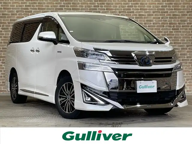 トヨタ ヴェルファイア ハイブリット X 岩手県 2019(令1)年 5.7万km ホワイトパールクリスタルシャイン ４WD/モデリスタエアロ/両側パワースライドドア/ALPINEビッグXナビ１１インチナビ/フルセグTV/トヨタセーフティセンス/プリクラッシュセーフティ/レーダークルーズコントロール/レーントレーシングアシスト/オートマチックハイビーム/クリアランスソナー/先行車発進告知機能/横滑り防止装置/MTモード付AT/レザー調シートカバー/リヤオートエアコン/バックカメラ/サイドカメラ/ETC/ドライブレコーダー/LEDヘッドランプ/LEDフォグランプ/社外１７インチアルミホイール