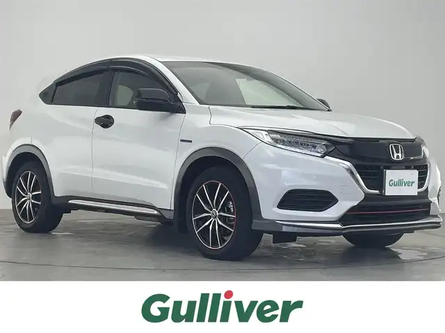 ホンダ ヴェゼル ハイブリッド ホンダセンシング 滋賀県 2019(平31)年 2万km プラチナホワイトパール 禁煙車/純正ナビ/（CD/SD/Bluetooth）/バックカメラ/前後ドライブレコーダー/ビルトインETC/衝突被害軽減ブレーキ/路外逸脱抑制システム/レーンキープアシストシステム/標識認識機能/革巻きステアリング/アダプティブクルーズコントロール/ステアリングリモコン/LEDヘッドライト/オートヘッドライト/純正アルミホイール/レザー調シートカバー/電動パーキングブレーキ/オートホールドブレーキ