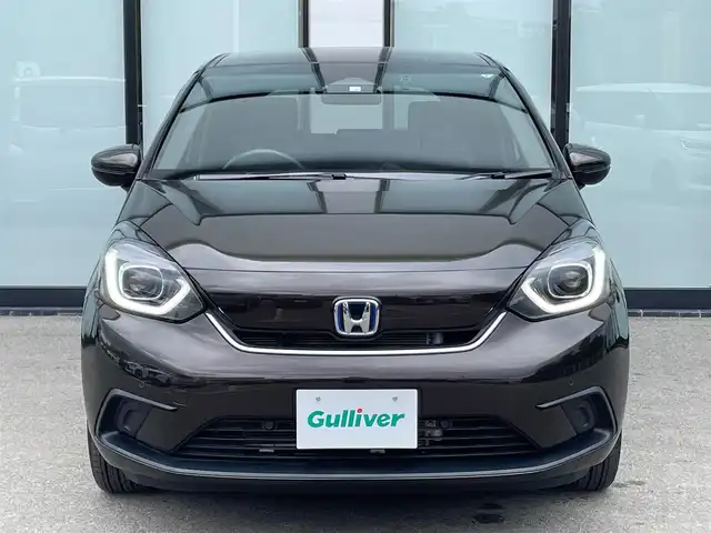 ホンダ フィット e:HEVホーム 大阪府 2020(令2)年 3.8万km プレミアムグラマラスブロンズP 純正８インチナビ/  フルセグTV/CD/DVD/Bluetooth/USB/バックモニター/横滑り防止装置/衝突軽減ブレーキ/コーナーセンサー/レーダークルーズコントロール/レーンキープアシスト/ステアリングスイッチ/アイドリングストップ/オートマチックハイビーム/純正15インチアルミホイール/ハーフレザーシート/純正フロアマット/プッシュスタート/スマートキー/ＥＴＣ/ＬＥＤライト/禁煙車