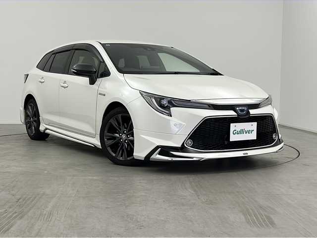 トヨタ カローラツーリング ハイブリッド ダブルバイビー 三重県 2019(令1)年 4.3万km ホワイトパールクリスタルシャイン 禁煙車　/純正９インチナビ機能つきディスプレイオーディオ　/バックカメラ　/モデリスタフルエアロ　/トヨタセーフティセンス　/衝突被害軽減ブレーキ　/レーンキープアシスト　/オートハイビーム　　/純正ビルトインＥＴＣ/オートAC/電子サイドブレーキ/ブレーキオートホールド/ステアリングスイッチ
