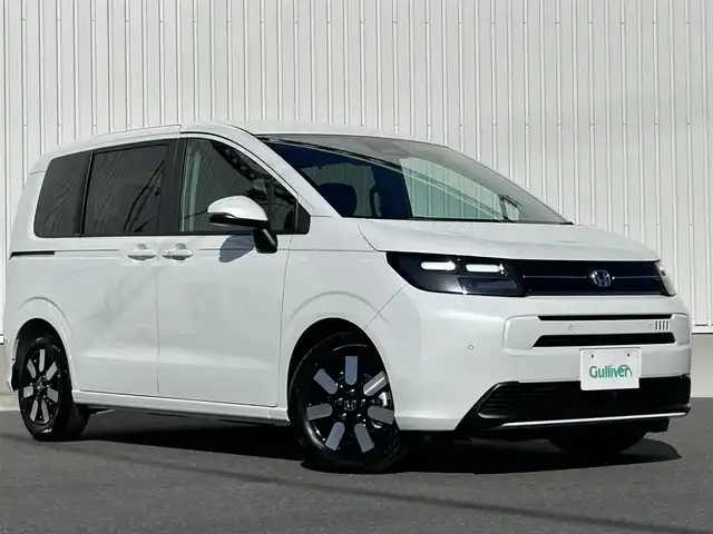 ホンダ フリード ハイブリット e:HEV AIR EX 群馬県 2025(令7)年 0.1万km プラチナホワイトパール ホンダセンシング/・衝突軽減ブレーキ（CMBS）/・歩行者事故低減ステアリング/・路外逸脱抑制機能/・渋滞追従機能付アダプティブクルーズコントロール/・車線維持支援システム（LKAS）/・ブラインドスポットインフォメーション/・誤発進抑制機能/・後方誤発進抑制機能/・パーキングセンサーシステム/・アダプティブドライビングビーム/両側パワースライドドア/LEDヘッドライト/ハーフレザーシート/D/Nシートヒーター/プッシュスタート/スマートキー/ステアリングリモコン/純正15インチアルミホイール