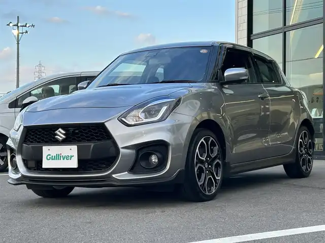 スズキ スイフト スポーツ 愛媛県 2023(令5)年 5万km プレミアムシルバーメタリック 6速MT/純正8型ナビ（Bluetooth/フルセグTV）/アラウンドビューモニター/アダプティブクルーズコントロール/ETC/前後ドライブレコーダー/純正フロアマット/純正17インチアルミホイール/ブラインドスポットモニター/スズキセーフティサポート/ステアリングリモコン/トノカバー/前後コーナーセンサー/LEDヘッドライト/スマートキー