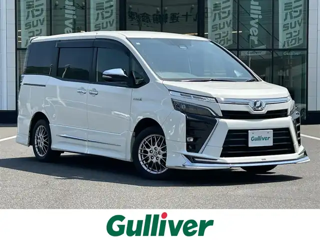 トヨタ ヴォクシー ハイブリッド ZS 煌Ⅱ 岡山県 2019(平31)年 5.1万km ホワイトパールクリスタルシャイン モデリスタエアロ/純正10インチナビ/（AM.FM.BT.TV.CD.DVD）/純正フリップダウンモニター/両側パワースライドドア/トヨタセーフティセンス/・プリクラッシュセーフティ/・オートマチックハイビーム/・レーンディパーチャアラート/バックカメラ/LEDヘッドライト/フォグランプ/びるといんETC/WAC
