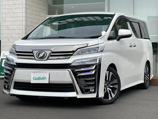 トヨタ ヴェルファイア ZG 道央・札幌 2018(平30)年 0.5万km ホワイトパールクリスタルシャイン ・４WD/・ワンオーナー/・衝突軽減ブレーキ/・寒冷地仕様/・両側パワースライドドア/・ローダウン/・ハーフレザーシート/・パワーシート/・ブラインドスポットモニター/・デジタルインナーミラー/・純正ナビ/　CD＆DVD＆BT＆TV/・バックカメラ/・フリップダウンモニター/・パーキングアシスト/・レーダークルーズコントロール/・シートヒーター/・アイドリングストップ/・コーナーセンサー/・レーンキープアシスト/・純正エンジンスターター/・前後ドライブレコーダー/・パワーバックドア/・オートエアコン/・オートライト/・オートリトラミラー/・レインセンサーワイパー/・ワイパー熱線/・ステアリングヒーター/・プッシュスタート/・スマートキー/・MT付きAT/・ビルトインETC/・社外AW＆冬タイヤ積込/・純正サスペンション積込/・JBLプレミアムサウンド/・純正フロアマット/・ウィンカーミラー/・フォグライト/・ドアバイザー/・スペアキー